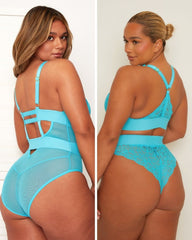 Woman wearing a turquoise lace lingerie set from back view.