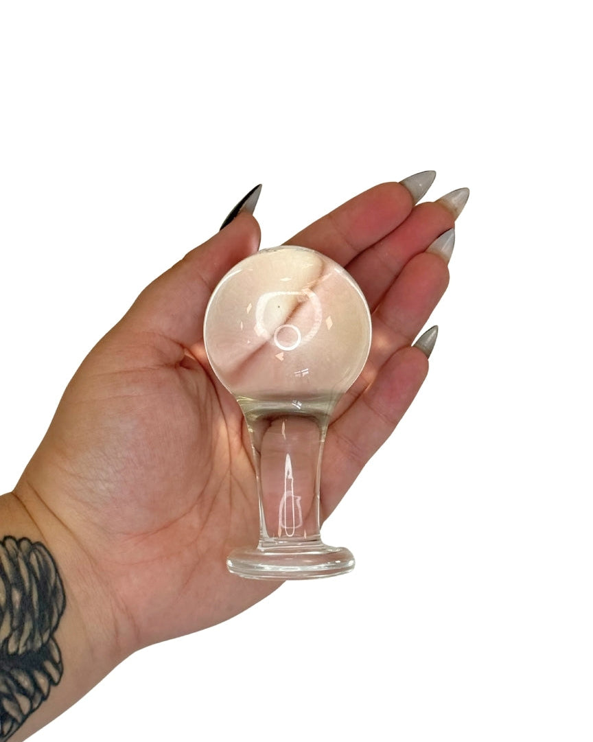Hand holding a small glass Butt Plug