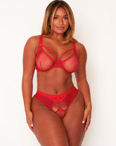 Woman wearing a red lingerie set on a white background