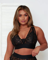 Model posing in the Hallie Bralette and High Waist Brief in Black by Tutti Rouge, showcasing soft floral lace, sheer mesh accents, and a comfortable wide waistband.
