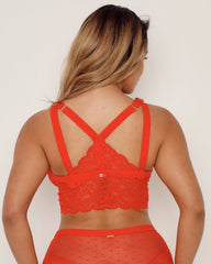 Red lace lingerie set on a plain background