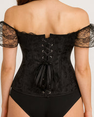 Black lace corset worn by a model on a plain background
