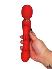 Red silicone wand massager held by a hand on a white background