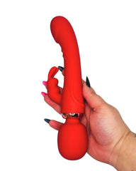Red silicone personal massager adult toy held by a hand with black nail polish on a white background