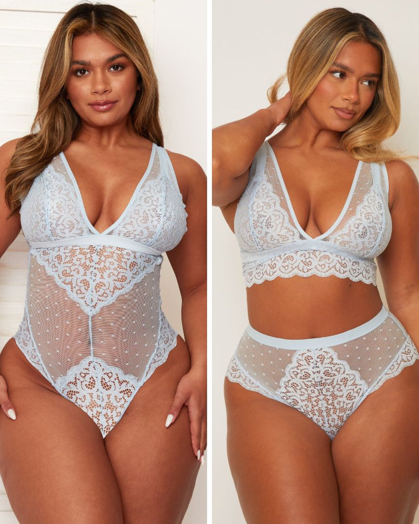 Woman wearing a white lace lingerie set against a plain background