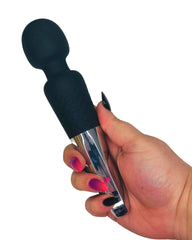 Hand holding a black and silver massage tool against a white background