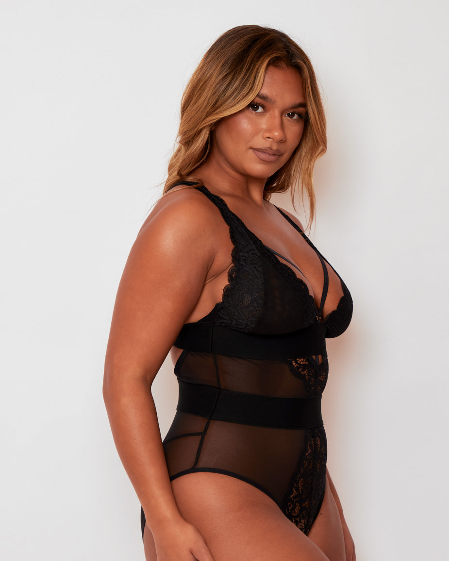 Side profile of the Alicia Bodysuit in Black by Tutti Rouge, showcasing sheer mesh construction, delicate lace cups, and a sculpting high-waist design.
