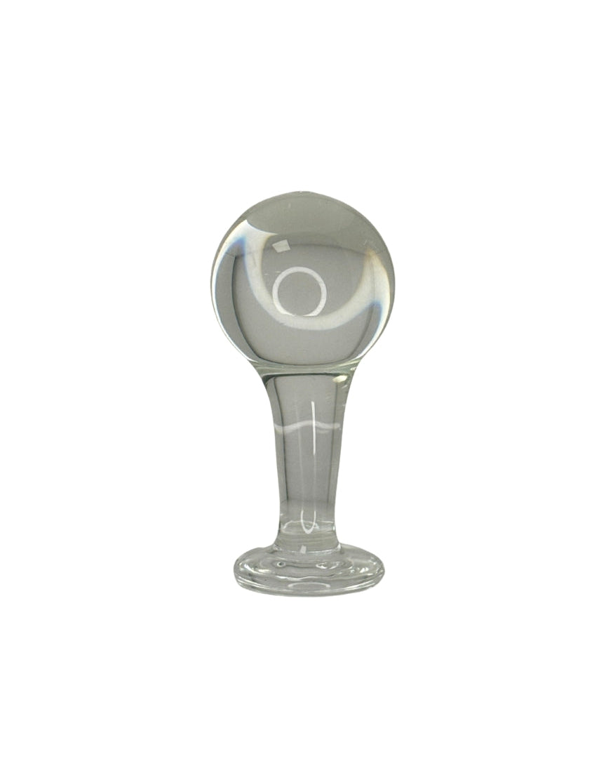 Clear glass Butt Plug with a cylindrical base and spherical top on a white background