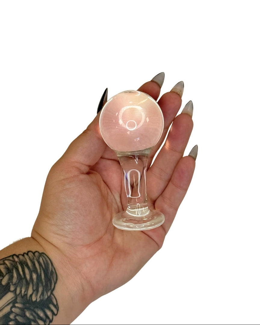 Hand holding a small glass Butt Plug  