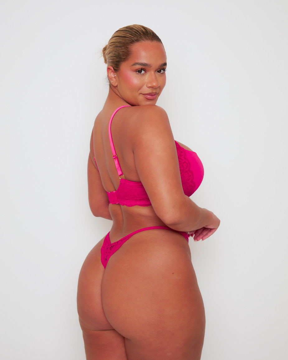 Three-quarter back view of the Daley T-Shirt Bra and Portia Thong in Very Cherry, showing the intricate floral lace detailing, adjustable fit, and sleek thong silhouette from behind.