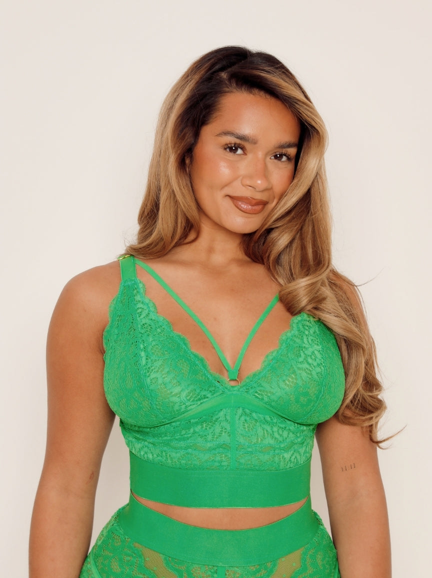 Woman wearing green caged lingerie bralette
