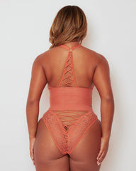 Rear view of the Maya Bralette & Brief Set in Cider Orange, highlighting the racerback lace-up detail, flattering Brazilian-style brief, and delicate floral lace for an eye-catching finish.