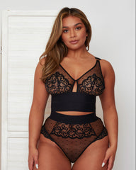 Front view of the Morgon Bralette and Brief set in Midnight Black, featuring sheer polka-dot mesh, floral lace detailing, and a striking keyhole cut-out at the centre front. Wide elastic bands create a flattering, supportive silhouette.