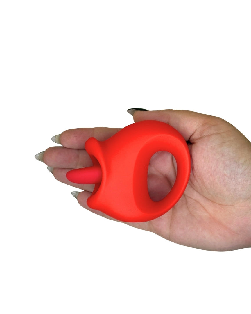 Red silicone ring held in a hand on a white background