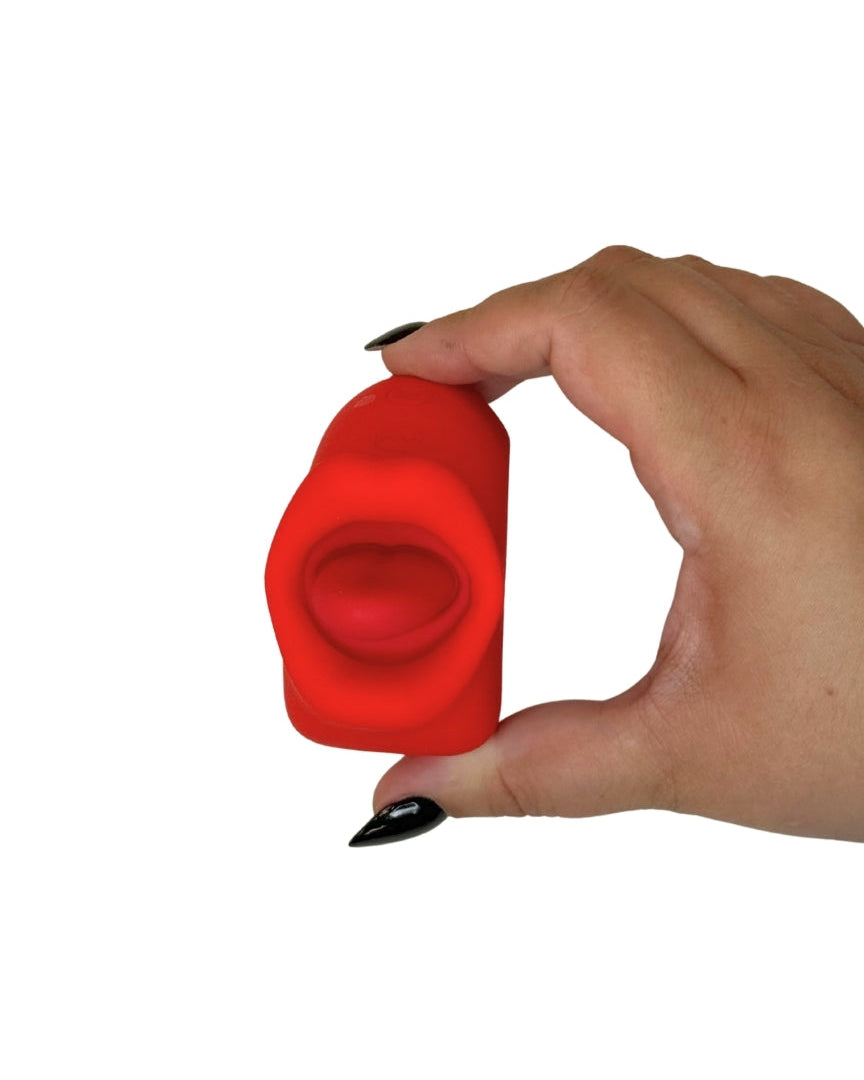 Hand holding a red silicone vibrator against a white background