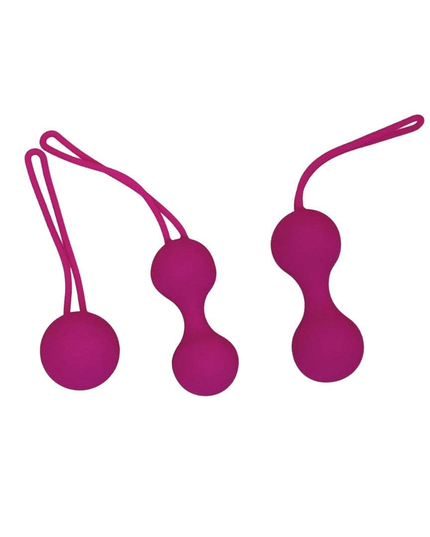Two pink silicone balls with strings on a white background